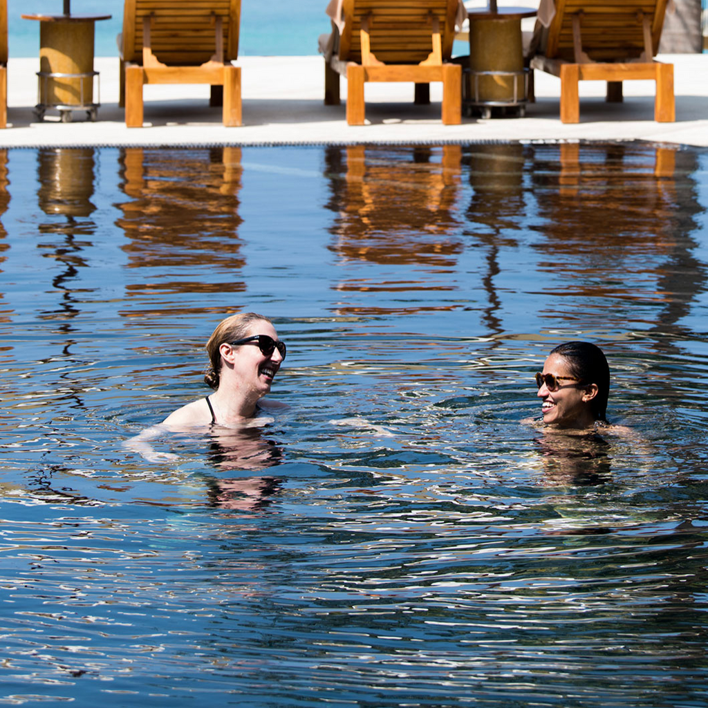 two women swimming smiling in pool thailand Loop Swim 